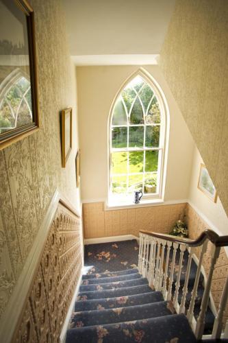 Looking down the stairs from the first floor of the main Altonlea Lodge, with a view out to our garden